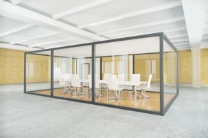 Modern modular office space with glass walls and white furniture, emphasizing flexible and efficient workspace solutions for Dallas Pallet Racking services.
