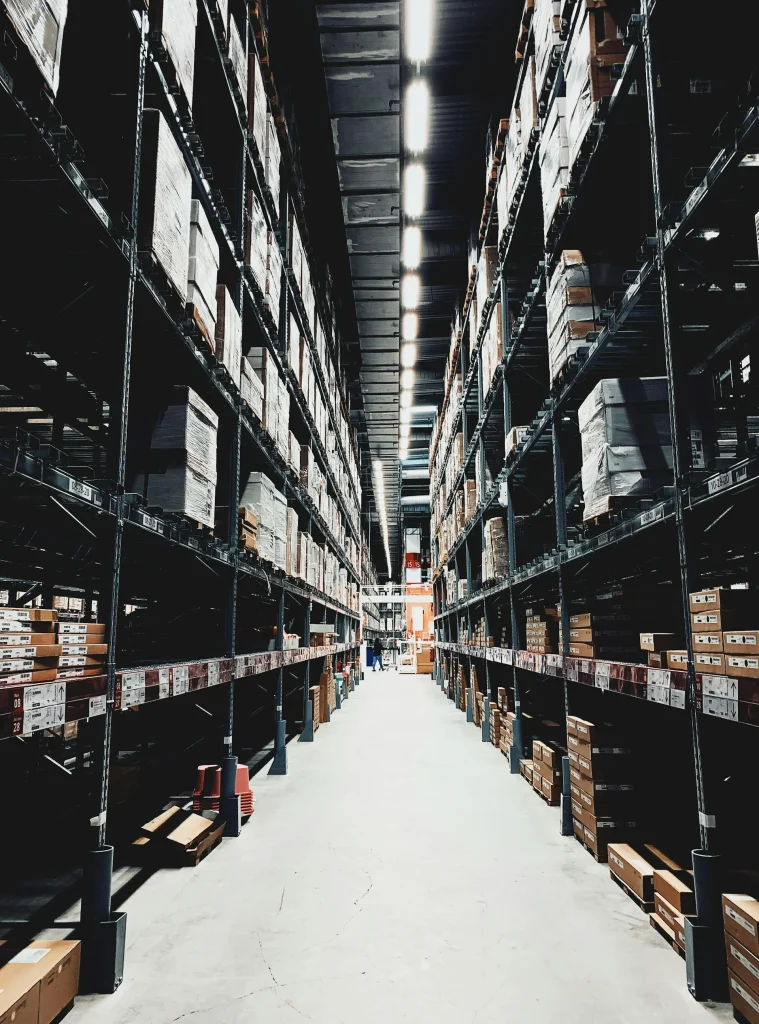 Warehouse shelving system displaying organized boxes and products, illustrating efficient storage solutions in a commercial setting.